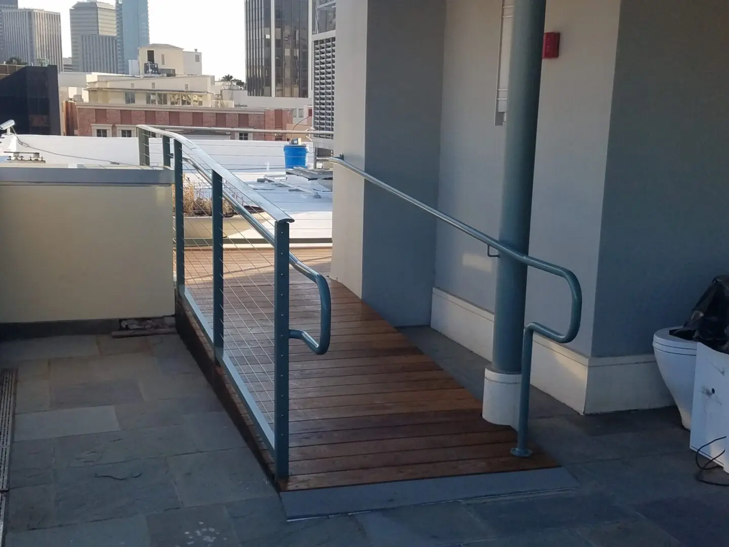 A wooden ramp with metal railing on top of it.