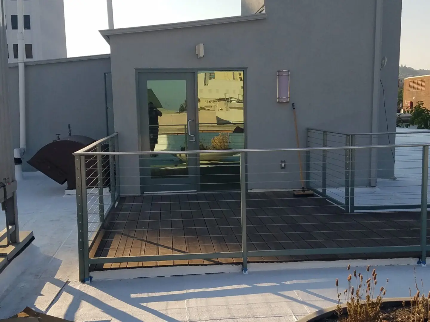 A balcony with a metal railing and glass door.