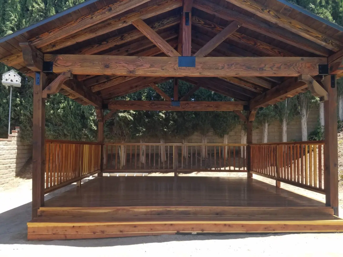 A large wooden structure with a roof and a deck.