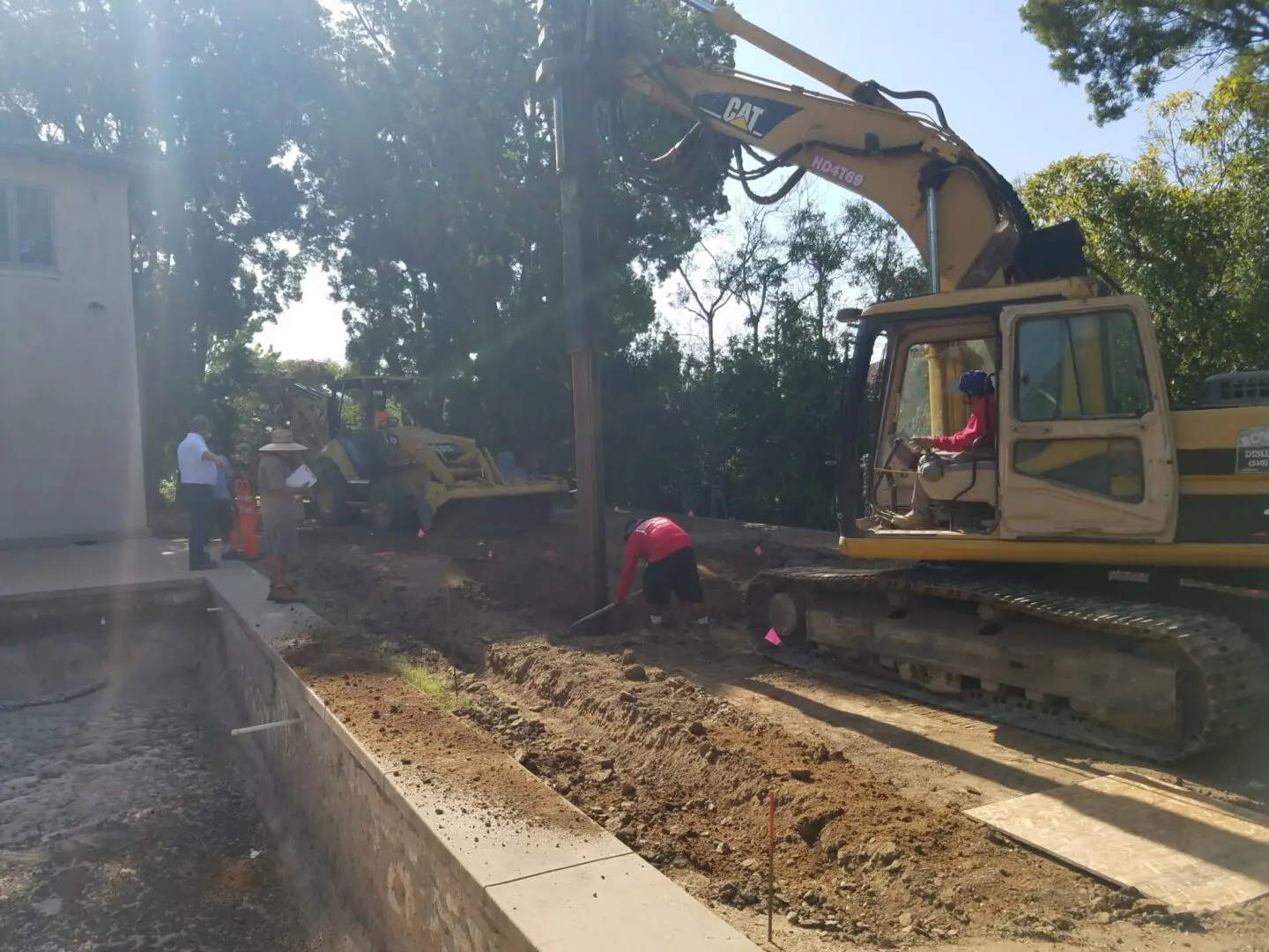 A group of people standing around digging up dirt.