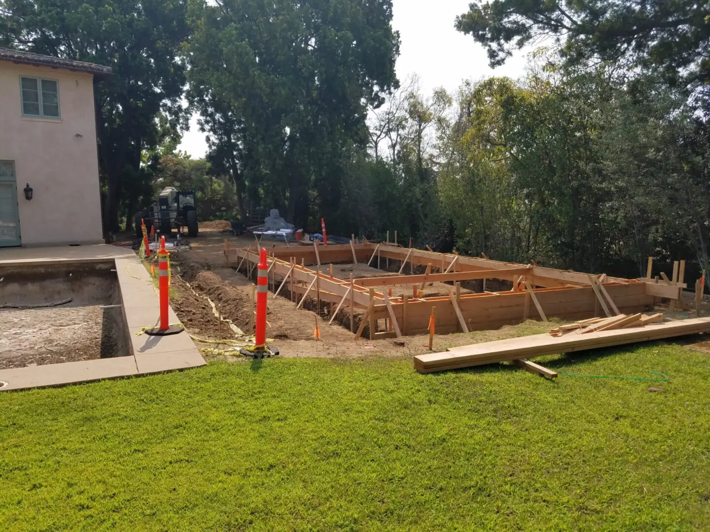 A large concrete slab being built in the yard.