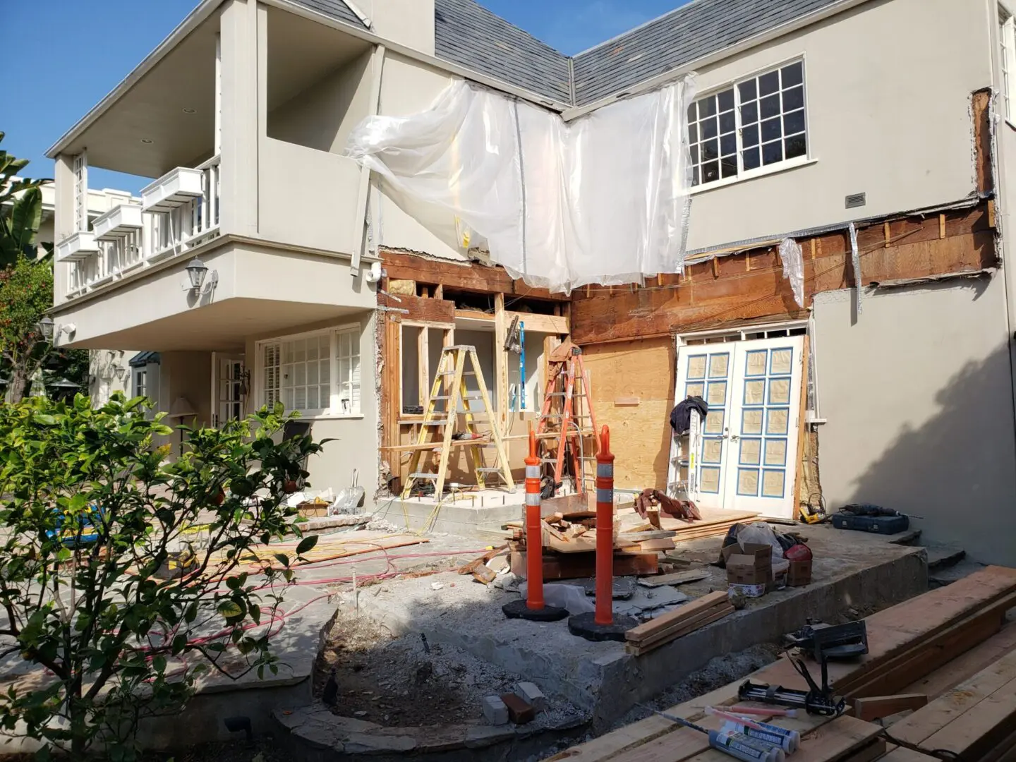 A house being remodeled with construction equipment.