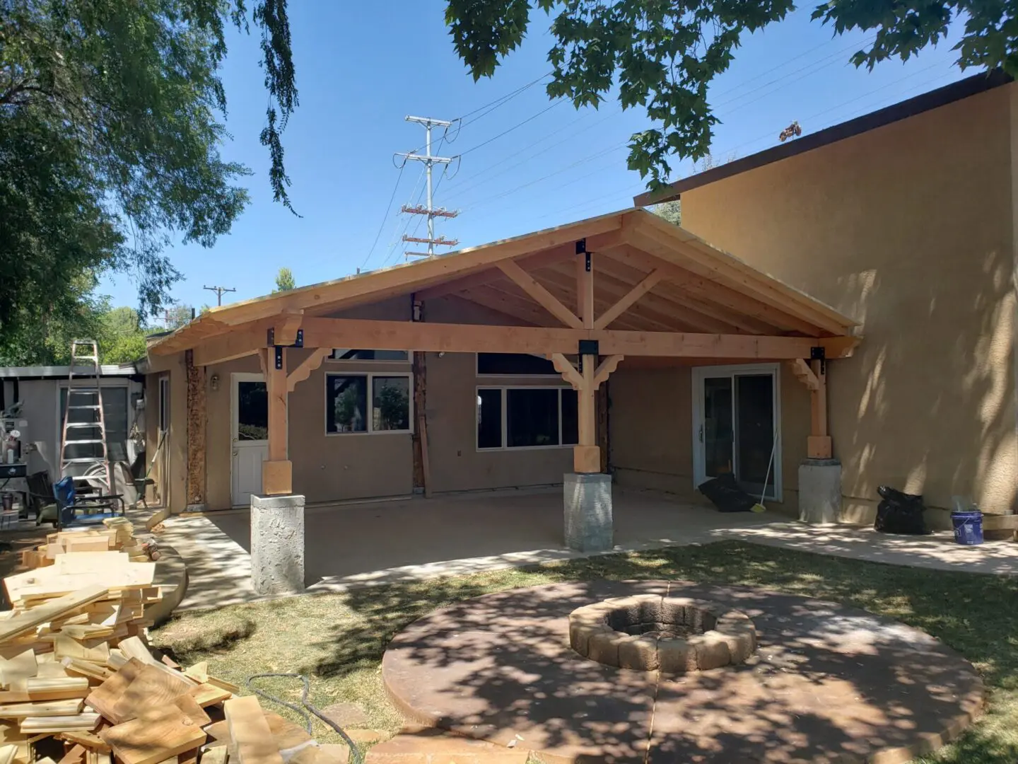 A large wooden structure sitting in the middle of a yard.