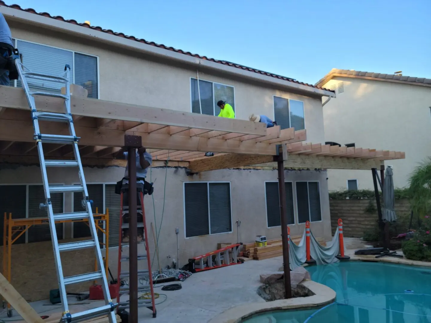 A man is working on the roof of his home.