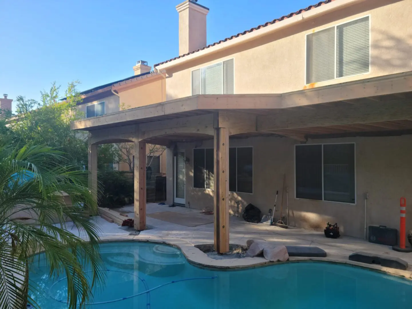 A large pool with an awning over the top of it.