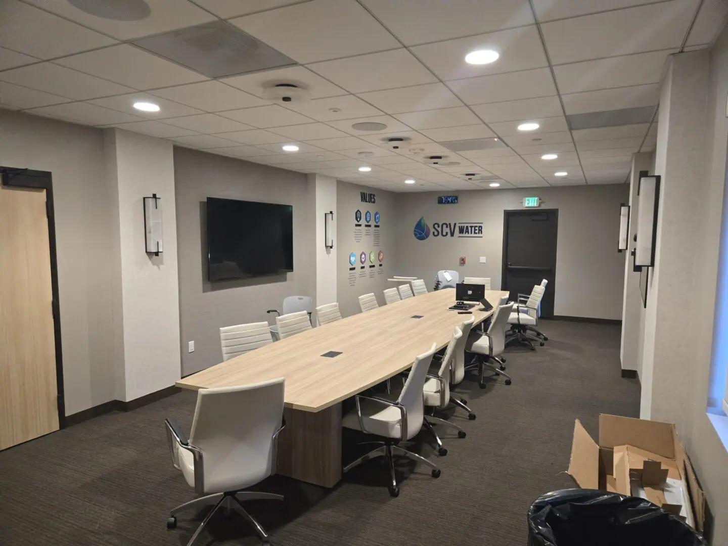 A large conference room with a long table and chairs.