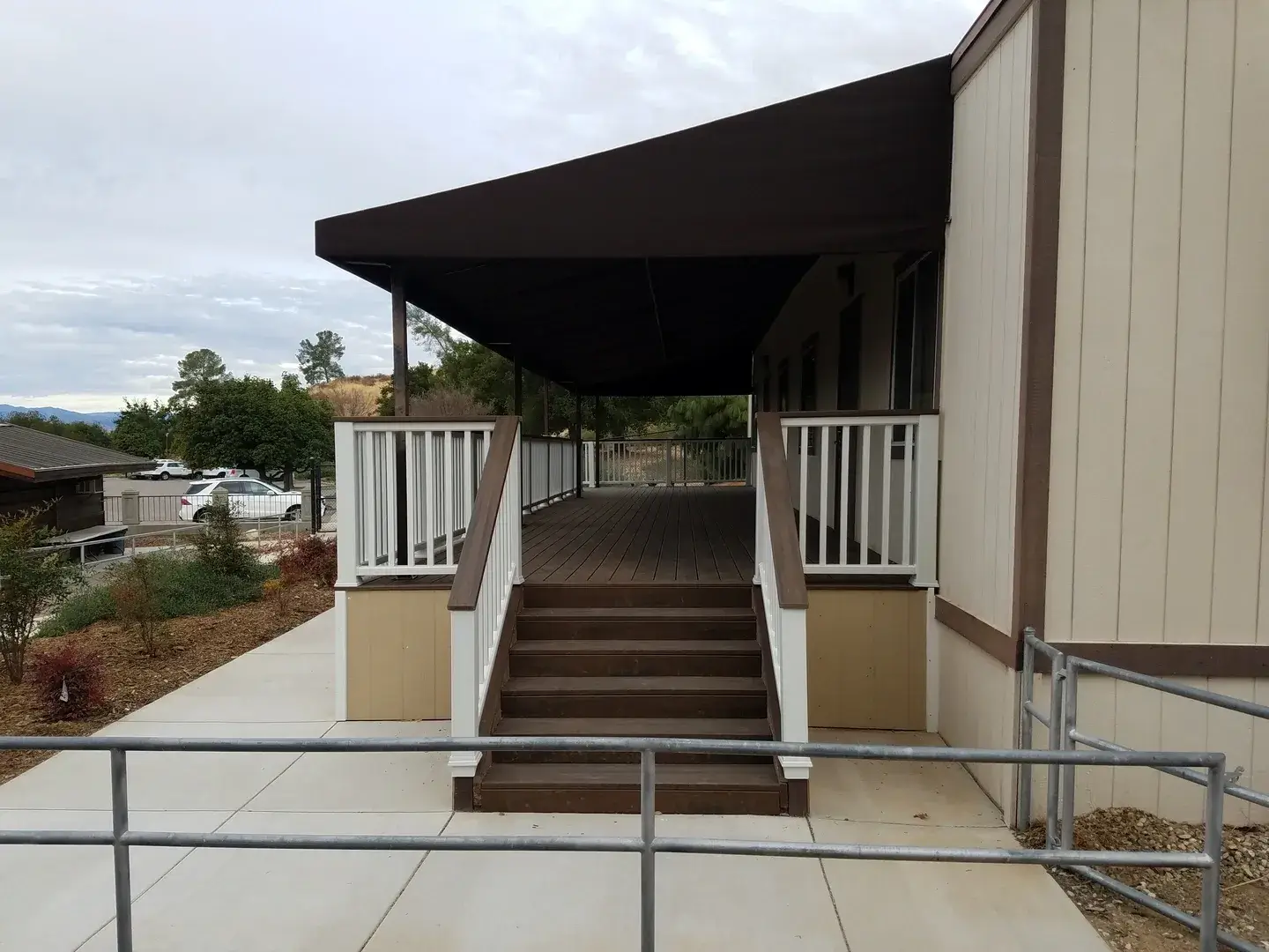 A walkway with steps leading to the top of stairs.